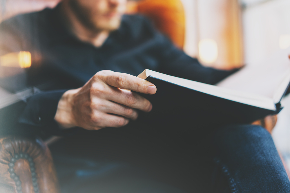a man reading a great business book