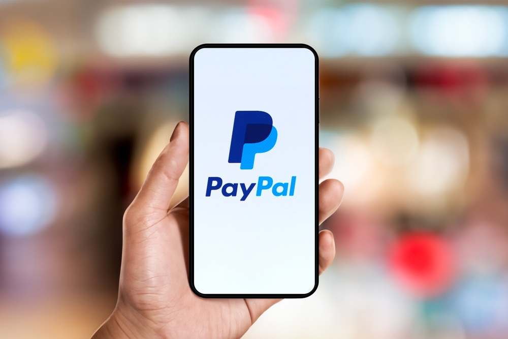 hand holding phone with PayPal apps on the screen